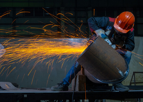 Welder working on a custom pipe system
