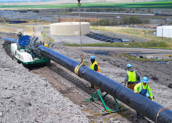 Intermech team members installing piping for a wastewater disposal client
